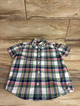 Top-down view of toddler short-sleeve green plaid button-down shirt size 5T showing buttons and collar on wood background