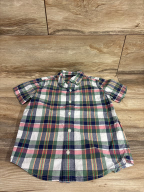 Top-down view of toddler short-sleeve green plaid button-down shirt size 5T showing buttons and collar on wood background