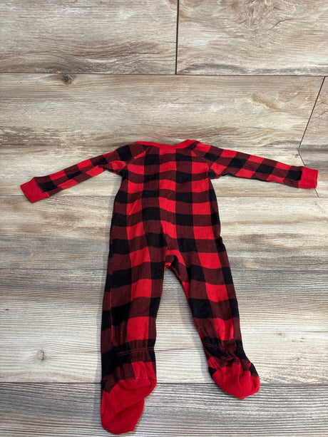 Red and black plaid footed baby sleeper on wood background, long sleeves, cozy kids clothing