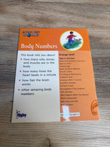 Discovery World Body Numbers children's book cover on wood table, educational kids science book