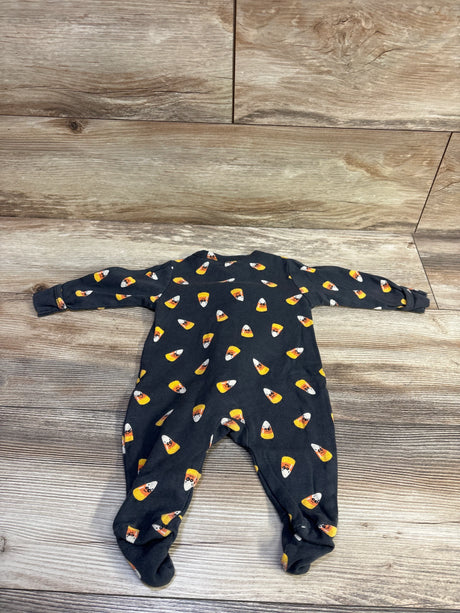 Flat lay of grey Old Navy footed baby sleeper showcasing all-over candy corn print and fold-over cuffs on wood floor