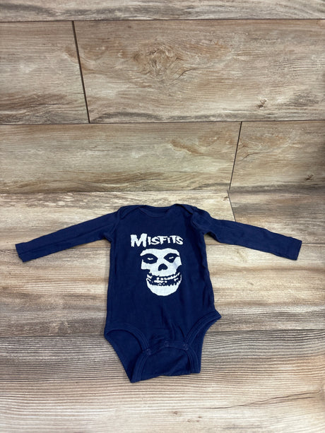 Top view of navy Misfits long sleeve bodysuit in size 6m with white skull graphic and snap closures on wood-grain floor