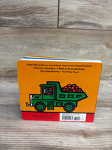 Back view of Machines At Work board book showing green dump truck illustration on orange background on wood floor