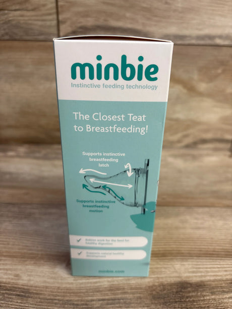 Front view of Minbie 6m+ feeding kit box showing teal packaging with headline The Closest Teat to Breastfeeding on wood backdrop