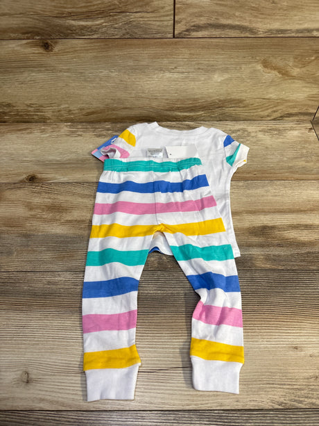 Flat lay of Ms Rachel 2-piece baby pajama set showing white top and striped leggings on wood background