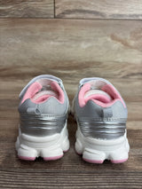 Rear view of Carter's toddler sneakers size 9C, silver and white with pink padded collars and pink sole accents on wood