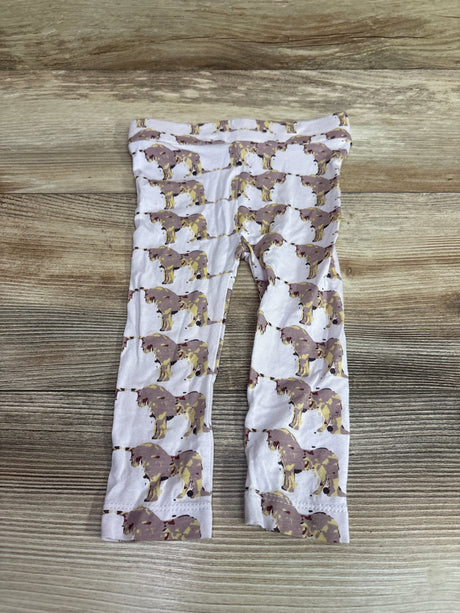 Kate Quinn pink bamboo baby pants with unicorn print on a wood background