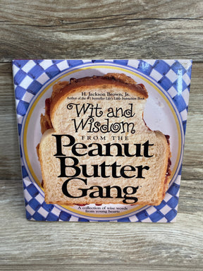 Front cover of Wit and Wisdom from the Peanut Butter Gang hardcover showing a sandwich on a blue-checkered plate on wood