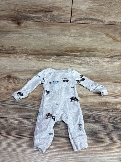 Grey Carter's footless baby sleeper with bison and nature prints on a wood floor