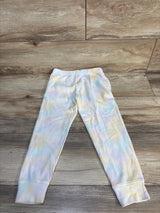 Pastel tie-dye ribbed kids leggings displayed on wood floor
