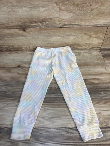 Pastel tie-dye ribbed kids leggings displayed on wood floor