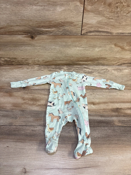 Flat lay of newborn mint green footed sleeper with farm animal print and diagonal front zipper on wooden background