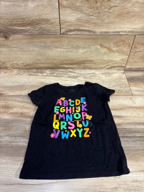 Front view of Children’s Place black ABCs shirt in size 5T showcasing colorful alphabet lettering on a wood floor