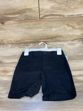 Front view of Cat & Jack black uniform shorts size 4T showing button waist, belt loops and front pockets on wood background