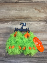 Bright green fuzzy monster baby shoes with orange toes, size 2, on hanger with tag