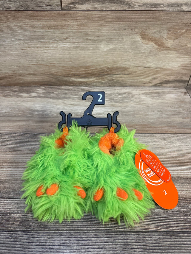 Bright green fuzzy monster baby shoes with orange toes, size 2, on hanger with tag