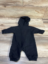 Black Adidas hooded baby coverall laid flat on a light brown wood floor.