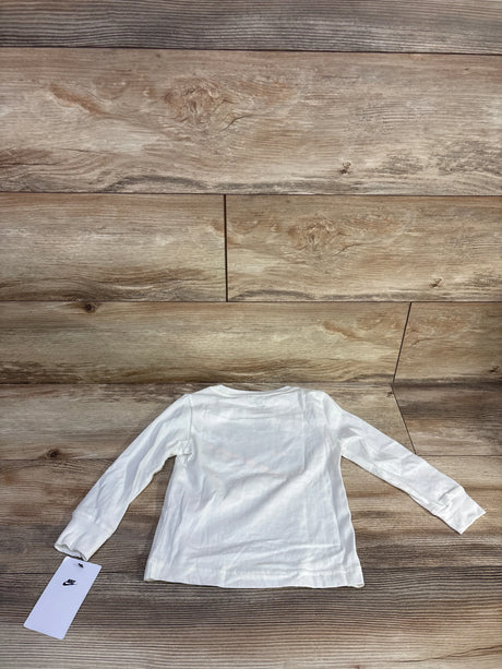 Back view of white Nike long sleeve toddler shirt (2T) laid flat on wood floor with visible Nike tag