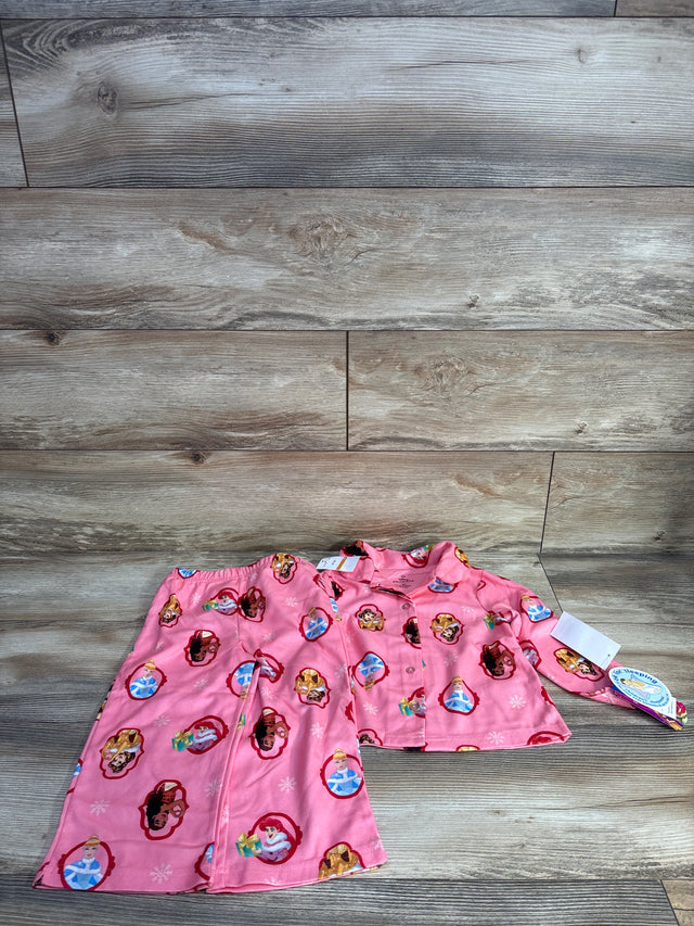 Front view of girls' pink Disney Princess 2pc button-up pajamas with button-front top and elastic pants on wood floor