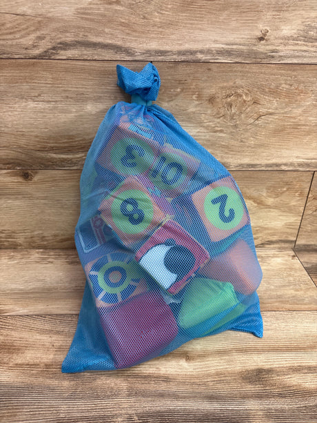 Front view of Melissa and Doug Ks Kids Match and Build Soft Blocks 14pc in blue mesh bag on wood floor