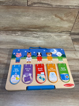 Front view of Melissa and Doug My Daily Day and Night Wooden Routines Chart showcasing five routine cards on a wood grain floor