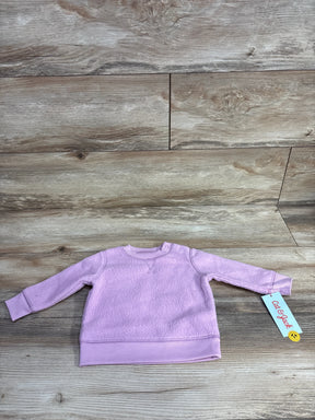 Light purple toddler fleece sweatshirt with long sleeves on wood background, Cat & Jack tag attached