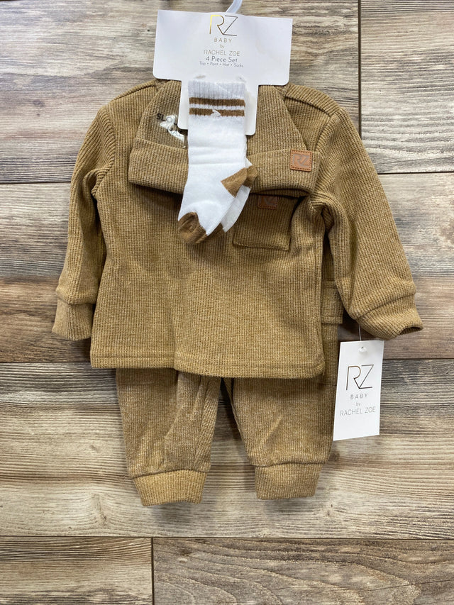 RZ Baby 4-piece beige knit set by Rachel Zoe including top, pants, hat, and white socks on wooden background