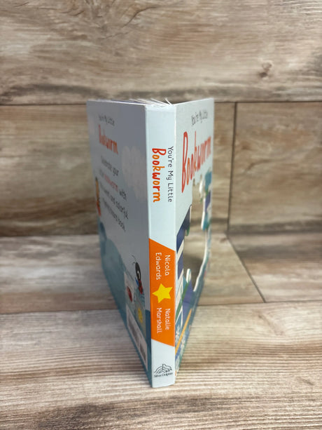 Angled view of You’re My Little Bookworm board book showcasing its colorful illustrated cover and spine on a wood-grain surface