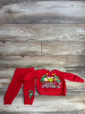 Red Grinch-themed toddler Christmas outfit with 'Merry Gringmas' sweater and gift-print pants on wood floor