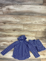 Flat lay of navy terry hoodie and matching shorts showcasing white horizontal stripes and hood on light wood floor background