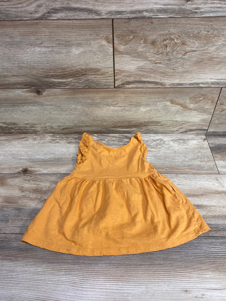 Front view of Cat and Jack orange eyelet sleeve dress in size 12 months showcasing lace sleeves and gathered skirt on wood grain