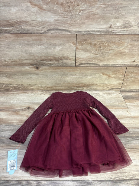 Flat lay of burgundy toddler long-sleeve sparkle ribbed tulle dress showcasing layered tulle skirt on wood background