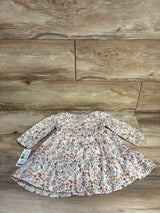 Flat lay of OshKosh white floral smocked long-sleeve dress and bloomers set showcasing smocked bodice and tiered skirt on wood background