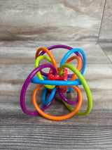 Colorful baby sensory teething toy with interconnected loops on wooden surface