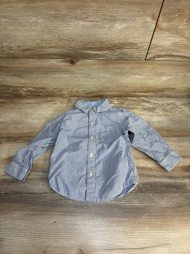 Striped long sleeve button-up toddler shirt on wood background
