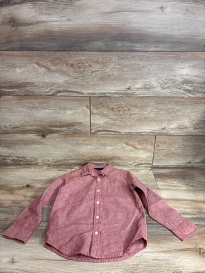 Front view of red linen-cotton long-sleeve button-up shirt (5T) with white buttons and chest pocket on wood background