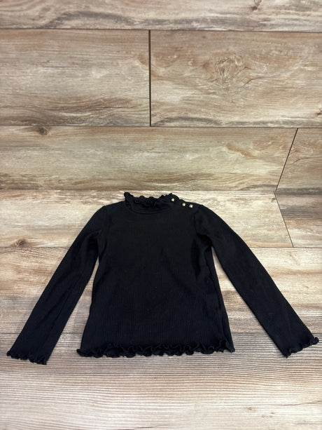Janie & Jack ribbed black turtleneck long sleeve shirt for toddlers on a wood background