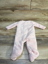 Pink plush baby sleep and play footie pajama by Me n Mommy To Be on a wooden background