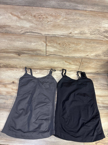 Flat lay of two nursing tank tops in grey and black showing adjustable straps and scoop necklines on wood floor