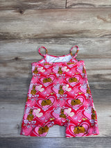 Flat lay of pink Shein x Scooby‑Doo shortie romper (2T) showing heart and Scooby‑Doo print on wood background