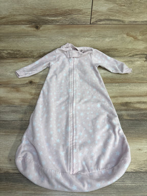 Light pink baby sleep sack with white star pattern and zipper on wooden surface