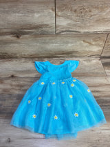 Flat-lay of turquoise toddler tulle dress size 2T with daisy applique skirt and flutter cap sleeves on wood background