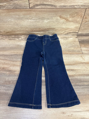 Flat lay of Cat & Jack blue flare jeggings size 2T showcasing elastic waistband and flared legs on wood background