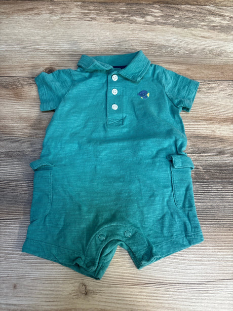 Teal baby romper with collar, short sleeves, buttons and small fish embroidery on wood background