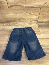 Back view of toddler blue distressed denim shorts size 2T showcasing elastic waistband and two back patch pockets on a wood floor
