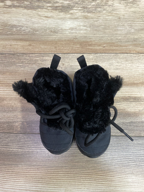 Top view of Nike Roshe One High TDV black winter boots showcasing fuzzy lining and laces on a wood-grain background