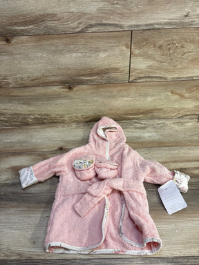 Flat lay of newborn pink hooded terry bath robe with matching booties, floral trim and tie belt on wood background