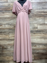 Front view of blush maternity maxi dress (XL) with V-neck wrap, braided waist, and flowing skirt against wood background