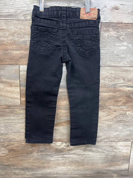 Black kids' jeans with back pockets, shown on wooden floor, gently used condition
