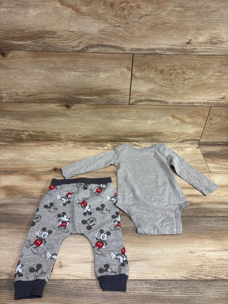 Top view of gray Disney Baby Mickey Mouse bodysuit and pants set with printed pants on wood-look flooring